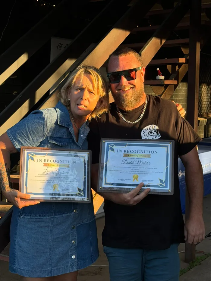 Two AAYDS team members holding their recognition certificates